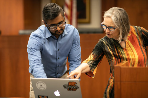 A female professor helping a male law student